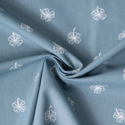 Tissu Popeline de Coton Clovers blancs sur fond Bleu - Par 10 cm