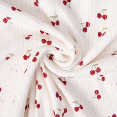 Tissu Jersey 100% Coton ajouré Baby petites cerises sur fond Ecru - Par 10 cm