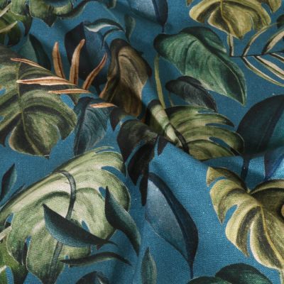 Tissu Toile de Coton Canvas Feuilles tropicales sur fond Bleu canard - Par 10 cm