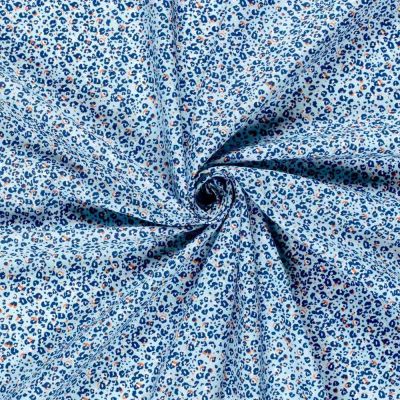 Tissu Popeline de Coton  panthère Nyra sur fond Bleu ciel - Par 10 cm