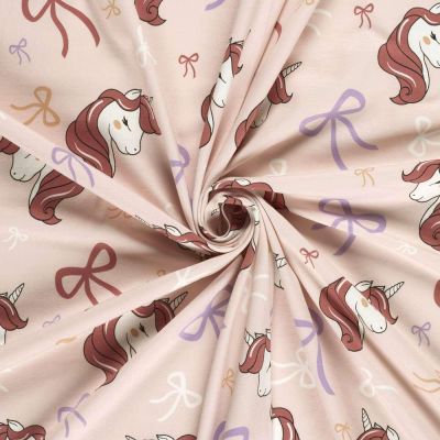 Tissu Jersey Coton imprimé Licorne et noeuds sur fond Rose bébé - Par 10 cm