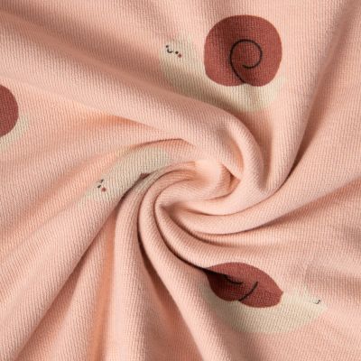 Tissu Maille Jersey Coton Lina escargots sur fond Rose nude - Par 10 cm