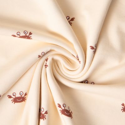 Tissu Jersey Coton imprimé crabes sur fond Beige - Par 10 cm