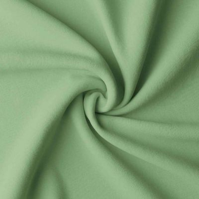 Tissu Coton enduit uni Vert amande - Par 10 cm