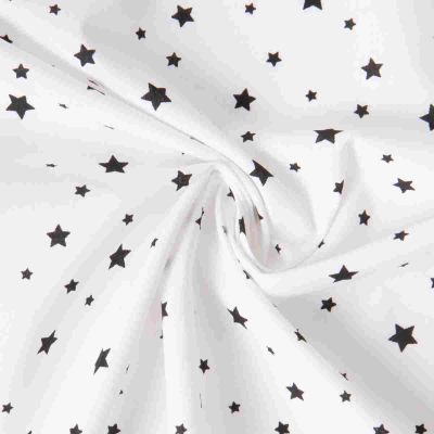 Tissu Coton imprimé Zetoil étoiles noires sur fond Blanc - Par 10 cm