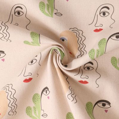 Tissu Coton imprimé Cielo Dessin visages sur fond Beige - Par 10 cm