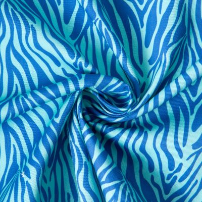 Tissu Toile de Coton Yara zebré Bleu sur fond Bleu turquoise - Par 10 cm