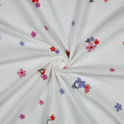 Tissu Double gaze de Coton Zohra petites fleurs brodées Bleu et Rose sur fond Blanc - Par 10 cm