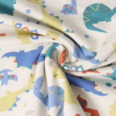 Tissu Sweat léger French Terry Léon dinos Bleus sur fond Blanc cassé - Par 10 cm