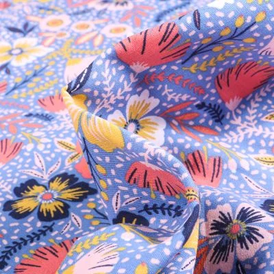 Tissu Coton imprimé Rizy sur fond Bleu - Par 10 cm