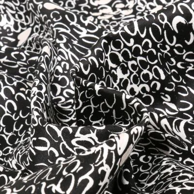 Tissu Coton Satiné extensible Merina sur fond Noir - Par 10 cm
